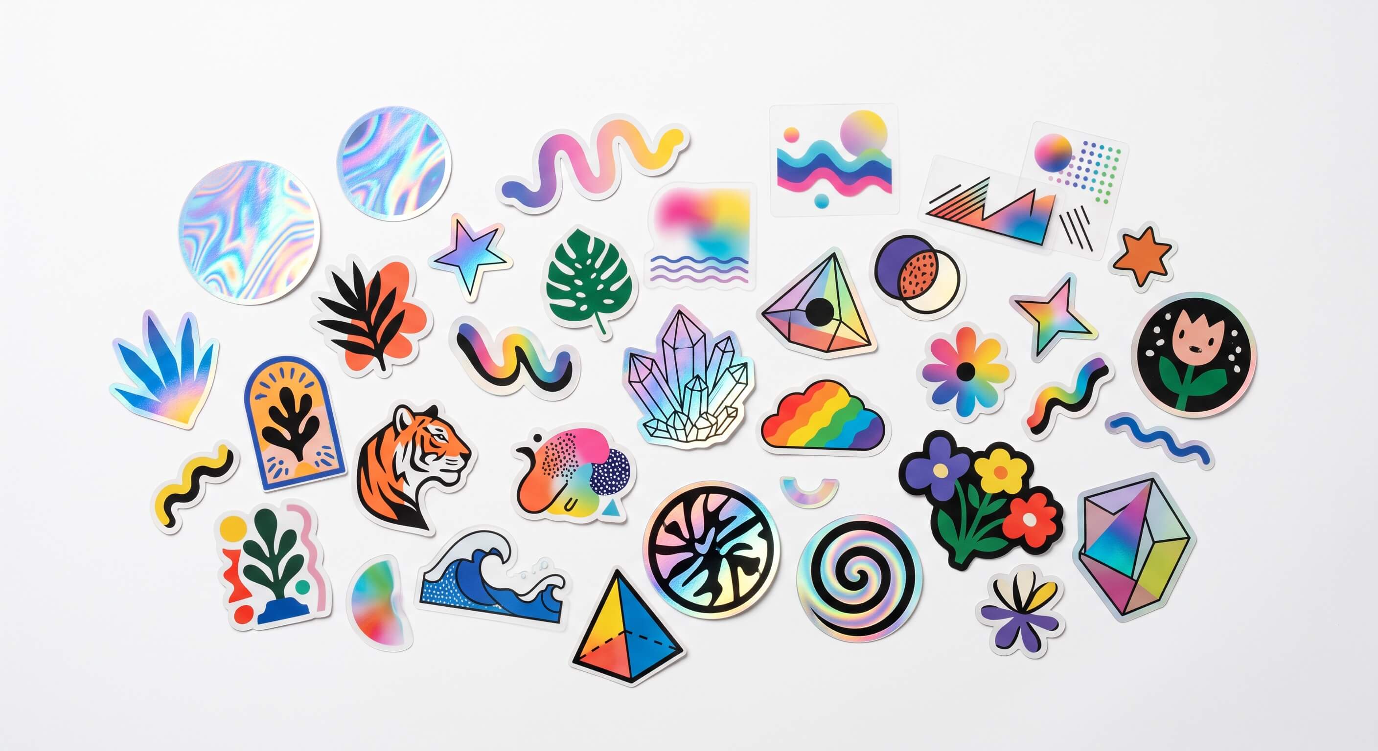 Assorted die-cut and holographic stickers in various shapes and designs on a white background